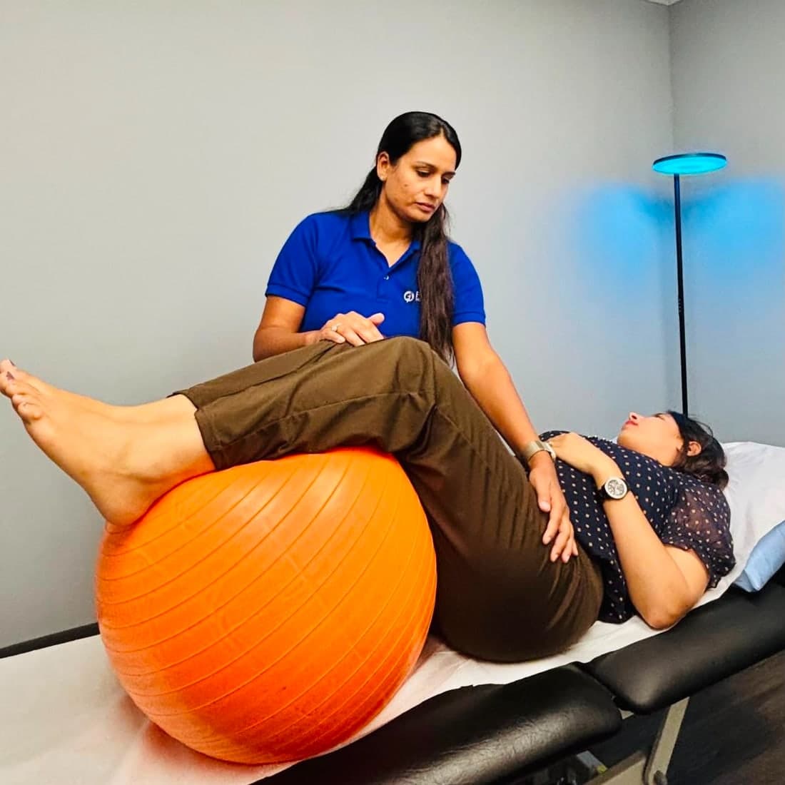 Hiral Desai guiding a pelvic floor physiotherapy exercise with a patient at Planet Health Care